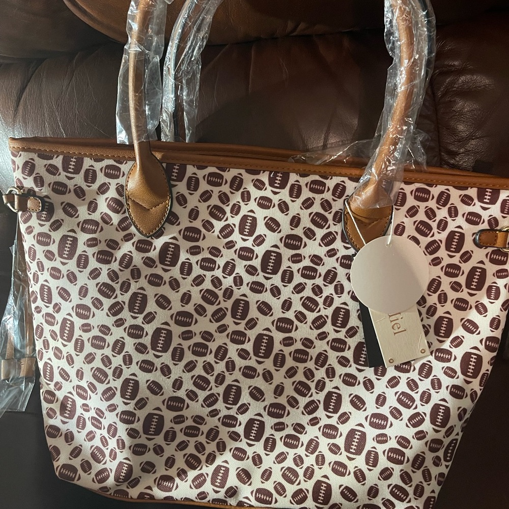 Large football purse with matching makeup bag and wallet inside!